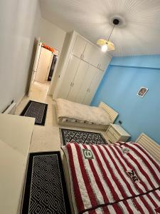 a room with three beds and a ceiling at EHDEN 3-3 apt in Ehden +6 photos