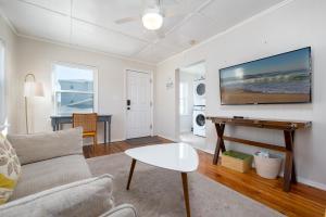 a living room with a couch and a table at Be A Nomad - Beach Bliss - Close to beach in Jacksonville Beach