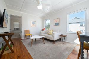 a living room with a couch and a table at Be A Nomad - Beach Bliss - Close to beach in Jacksonville Beach