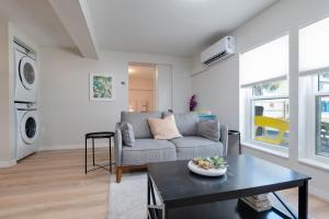 a living room with a couch and a table at Be A Nomad - Beach Bliss - Close to beach in Jacksonville Beach +41 photos