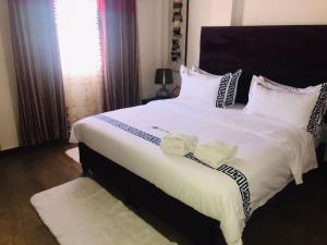 מיטה או מיטות בחדר ב-Agentour Guesthouses