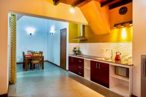 a kitchen with red cabinets and a dining room at Wintry Hills-Nuwara Eliya in Nuwara Eliya