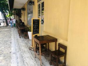 a group of tables and chairs sitting outside of a restaurant at Agentour Guesthouses in Luanda