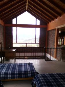 - une chambre avec un lit et une grande fenêtre dans l'établissement Casa De Los Colores, à Paipa