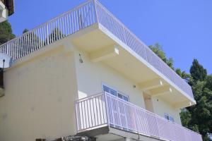 a white building with purple stairs on it at Saadhan Homestay in Mussoorie