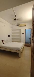 A bed or beds in a room at CGR PONDY