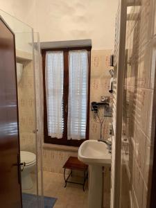 a small bathroom with a sink and a toilet at Casa in Umbria in Monte Castello di Vibio