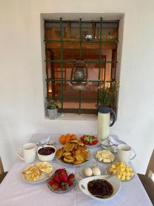a table with many plates of food on it at Guesthouse Vitoria - Mrizi i Zanave in Fishtë