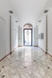 an empty room with a large window and a door at Elena House Apartments in Viareggio