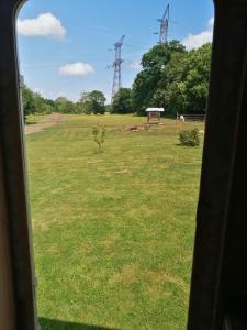 a view of a field from a train window at Camping à la ferme de la tournerie in Raids