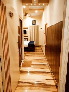 a corridor of a room with a bed and a hallway at Bhagyashree Guest House 2 KM to Vishwanath Temple, Ganga Ghat Parking Available in Varanasi