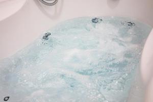 a bath tub filled with water in a sink at Elena House Apartments in Viareggio