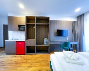 a hotel room with a bed and a red refrigerator at B-Chill Cologne in Cologne