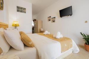 a bedroom with a bed with two stuffed animals on it at Studios Eliza in Livadi