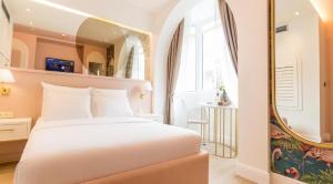 a bedroom with a white bed and a large mirror at Buldero Boutique in Budva