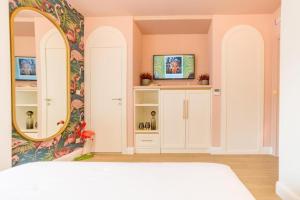 1 dormitorio con espejo y armario blanco en Buldero Boutique, en Budva