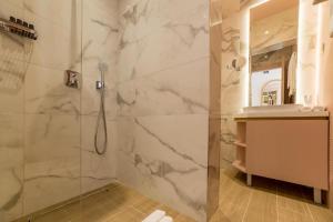 a bathroom with a shower with a glass door at Buldero Boutique in Budva