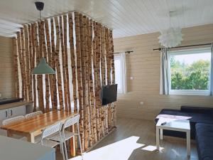 a living room with a wall of logs at Pod Wierzbami in Żuławki