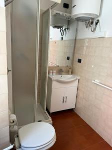 a bathroom with a toilet and a sink at Sori Mare in Sori