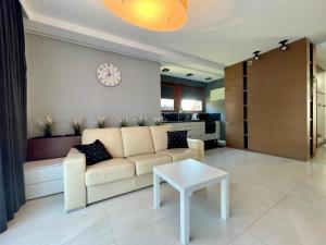 a living room with a couch and a table at Apartamenty-Baltivia in Hel