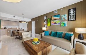 a living room with a couch and a table at Lyfe Oceanview Resort Luxury 2 Bedroom Unit in Hollywood