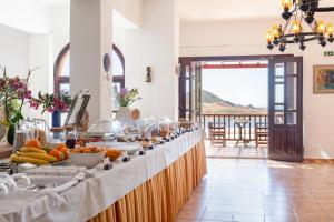 a buffet line with fruits and vegetables on it at Golden Sun Hotel Patmos in Patmos