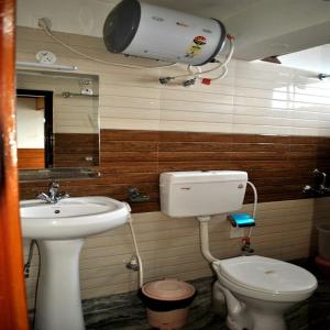 a bathroom with a toilet and a sink at Hotel Kasturi Palace Darjeeling - Excellent Service Recommended in Darjeeling