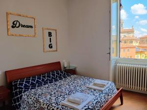 a bedroom with a bed and a large window at Casa Gregis - Museums Area - 10 min walk to Upper town in Bergamo
