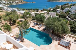 an aerial view of a villa with a swimming pool and the ocean at Golden Sun Hotel Patmos in Patmos