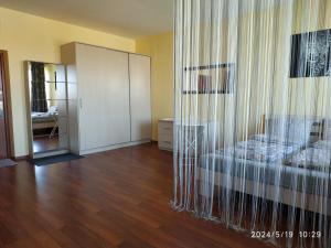 a living room with a bed and a closet at Small family apartment in Klaipėda