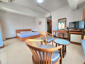 1 dormitorio con 1 cama, TV y mesa en Siam Palace Hotel en Bangkok