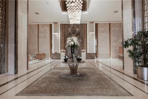 a lobby with a vase of flowers on a table at Concorde Tower Hotel & Casino in North Nicosia