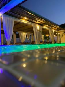 a close up of a swimming pool at night at Haber Hotel & SPA in Matemwe