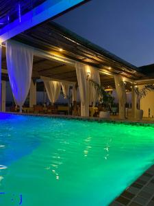 a swimming pool at night in a hotel at Haber Hotel & SPA in Matemwe