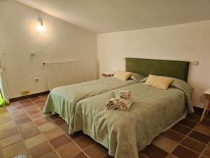 a bedroom with a bed with two towels on it at Finca Altair in Madrid