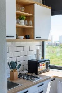 a kitchen with a toaster oven on a stove at Symphony Sea Shell in Eforie Nord