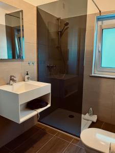 a bathroom with a sink and a shower at Pension Auer in Liebenfels