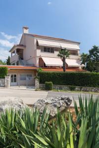 a large house in front of a street at Studio Ruzmarin in Krk