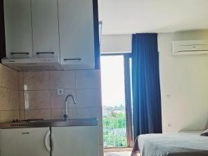 a kitchen with a sink and a window in a room at Apartments Casablanca in Podstrana +53 photos