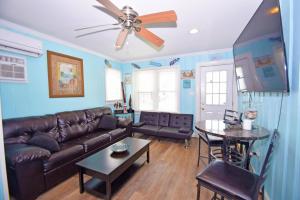 a living room with a couch and a table at Parrot Bay-Key Lime 7 condo in Ocean City