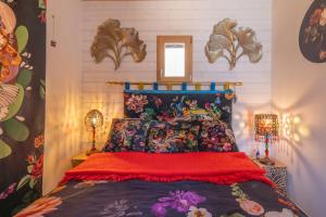 a bedroom with a bed with a colorful bedspread at La Bella Vista in Curel