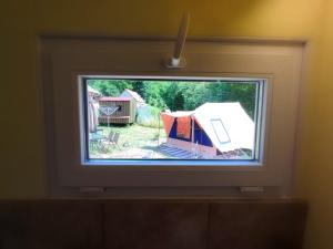 a tv screen with a view of a tent at Familytent "Kukucka" with private sanitary facilities - Holidayfarm Natural Slovakia in Modrý Kameň