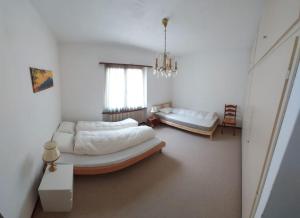 a living room with two beds and a couch at Casa Dolores in Lugano