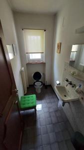 a bathroom with a green stool and a sink at Casa Dolores in Lugano