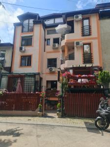 a house with a fence in front of it at Hotel Kapistec Skopje in Skopje