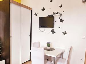 a dining room with butterflies on the wall at Apartments Casablanca in Podstrana