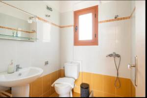 a bathroom with a toilet and a sink at Agnantio House in Monemvasia +19 photos