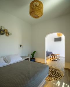 a bedroom with a bed and a circular rug at Athiri Luxury Suites in Perivolos
