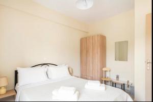 a bedroom with a white bed with two white pillows at Agnantio House in Monemvasia