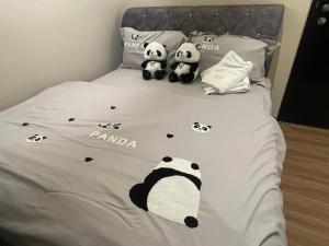 two panda stuffed pandas sitting on a bed at IPOH TAMBUN THE COVE Your Ultimate Relaxation Getaway777 in Ipoh